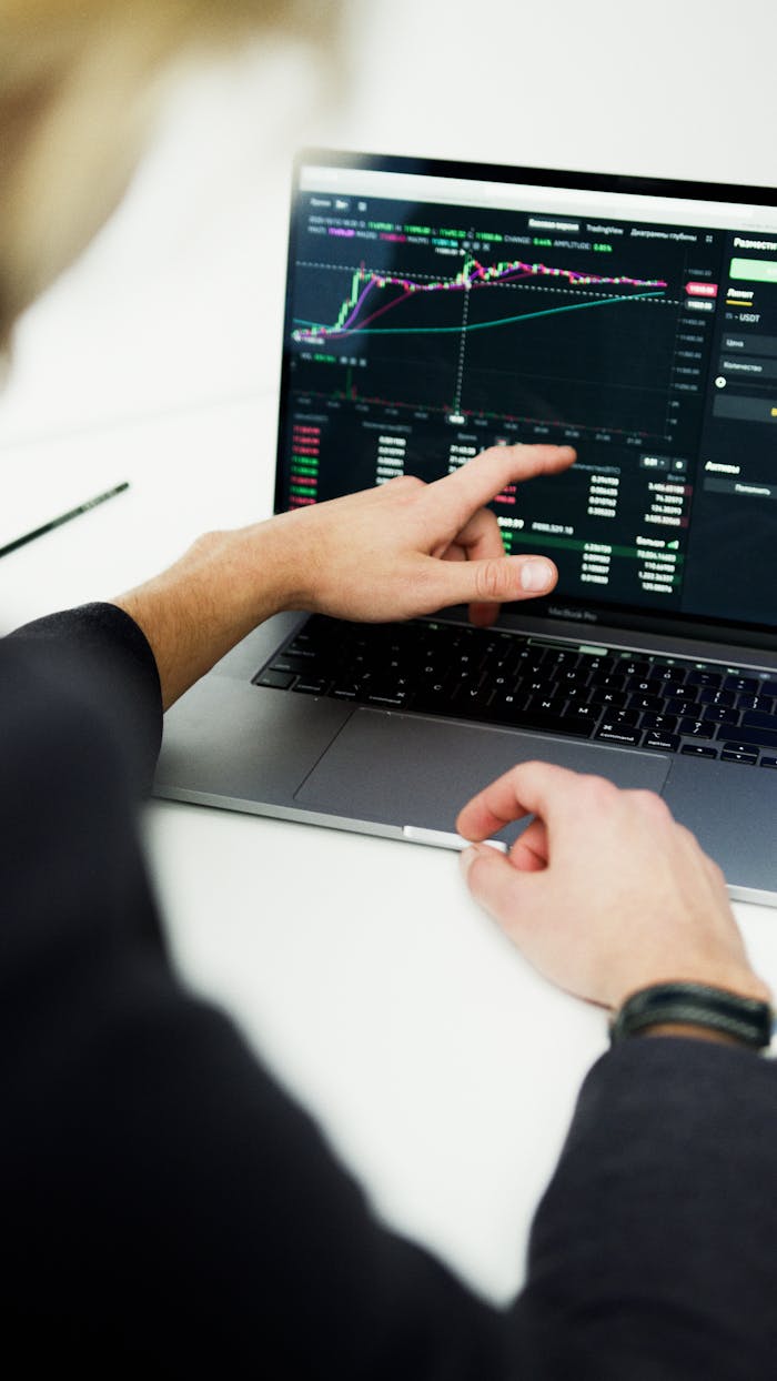 Business professional analyzing stock market trends on a laptop for financial planning.